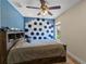 Bedroom with a unique geometric wall and a full-size bed at 9810 Camberley Cir, Orlando, FL 32836