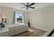 Bright bedroom with a twin bed, large window, and hardwood floor at 9810 Camberley Cir, Orlando, FL 32836