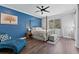 Spacious bedroom with a four-poster bed, blue accent wall, and ample floor space at 9810 Camberley Cir, Orlando, FL 32836