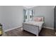 Cozy bedroom with a light-toned wooden bed frame and neutral decor at 9810 Camberley Cir, Orlando, FL 32836