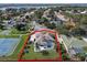 Aerial view of house, pool, and tennis/basketball courts at 9810 Camberley Cir, Orlando, FL 32836