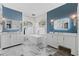 Luxurious bathroom with a freestanding tub, double vanity, and marble tile at 9810 Camberley Cir, Orlando, FL 32836