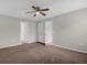 Bright bedroom with ceiling fan and access to other rooms at 506 Finch Ct, Poinciana, FL 34759