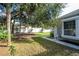 Spacious backyard with mature trees and a partially fenced area at 5646 Masters Blvd, Orlando, FL 32819