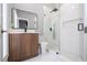 Modern bathroom with a walk-in shower, floating vanity, and mosaic tile at 5646 Masters Blvd, Orlando, FL 32819