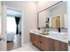 Modern bathroom with double vanity and a view into bedroom at 5646 Masters Blvd, Orlando, FL 32819
