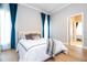 Bedroom with a queen bed and teal curtains at 5646 Masters Blvd, Orlando, FL 32819