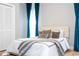 Bedroom with queen bed, gray blanket and teal curtains at 5646 Masters Blvd, Orlando, FL 32819