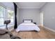 Well lit bedroom with a queen bed, hardwood floors and bay window at 5646 Masters Blvd, Orlando, FL 32819