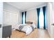 Bedroom with a queen bed and teal curtains at 5646 Masters Blvd, Orlando, FL 32819