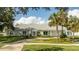 Gray house with white columns, landscaped yard, and circular driveway at 5646 Masters Blvd, Orlando, FL 32819