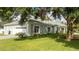 House exterior with a swing set and lush lawn at 5646 Masters Blvd, Orlando, FL 32819