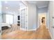 Light-filled hallway with hardwood floors and access to bedrooms at 5646 Masters Blvd, Orlando, FL 32819