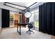 Bright home office features a large desk, comfortable chair, and plenty of natural light at 5646 Masters Blvd, Orlando, FL 32819