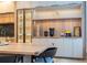 Modern kitchen with wood and gray cabinetry, and wine storage at 5646 Masters Blvd, Orlando, FL 32819