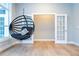 Relaxing office space with a hanging chair and hardwood floor at 5646 Masters Blvd, Orlando, FL 32819