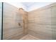 Elegant shower with wood-look tile and gold fixtures at 5646 Masters Blvd, Orlando, FL 32819