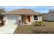 Newly constructed home with a one-car garage and a well-maintained lawn at 6921 Central Ave, Mulberry, FL 33860