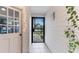 Side entry with white door and wrought iron gate at 821 Pine Shores Cir, New Smyrna Beach, FL 32168