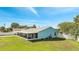 Home's backyard features a screened patio and large grassy area at 161 Laurel Way, Kissimmee, FL 34743