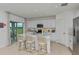 Modern kitchen with island, white cabinets, stainless steel appliances, and breakfast bar at 638 Teviot Rd, Haines City, FL 33844