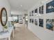 Bright and airy entryway with tile flooring, decorative mirror, and gallery wall at 638 Teviot Rd, Haines City, FL 33844