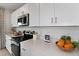 Modern kitchen with white cabinets and stainless steel appliances at 638 Teviot Rd, Haines City, FL 33844