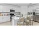 Modern kitchen with island, white cabinets, stainless steel appliances, and breakfast bar at 638 Teviot Rd, Haines City, FL 33844