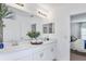 Double vanity bathroom with a large mirror and white cabinets at 638 Teviot Rd, Haines City, FL 33844