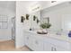 Double vanity bathroom with a large mirror and white cabinets at 638 Teviot Rd, Haines City, FL 33844