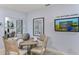 Casual dining area with round table, four chairs, and a modern media console at 638 Teviot Rd, Haines City, FL 33844