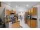 Modern kitchen with wood cabinets, stainless steel appliances, and granite countertops at 806 Knightsbridge Cir, Davenport, FL 33896