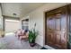 Covered porch with seating area, potted plant, and front entry at 806 Knightsbridge Cir, Davenport, FL 33896