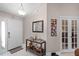 Bright entryway with console table, mirror, and French doors at 806 Knightsbridge Cir, Davenport, FL 33896