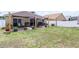 Large backyard with patio, shade sail and landscaping at 806 Knightsbridge Cir, Davenport, FL 33896