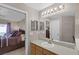 Bathroom with vanity, mirror and access to bedroom at 806 Knightsbridge Cir, Davenport, FL 33896