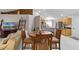 Open dining area with wood table and chairs overlooking kitchen at 806 Knightsbridge Cir, Davenport, FL 33896