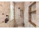 Walk-in shower with tiled walls and built-in shelving at 9792 Wild Oak Dr, Windermere, FL 34786
