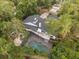 Aerial view of house, pool, and surrounding trees at 9792 Wild Oak Dr, Windermere, FL 34786
