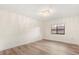 Bright bedroom with wood-look flooring and large window at 9792 Wild Oak Dr, Windermere, FL 34786