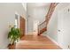 Bright entryway with hardwood floors, double doors, and elegant staircase at 9792 Wild Oak Dr, Windermere, FL 34786