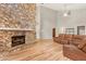 Living room with a stone fireplace and hardwood floors at 9792 Wild Oak Dr, Windermere, FL 34786