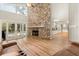 Living room with vaulted ceiling, stone fireplace, and access to backyard pool at 9792 Wild Oak Dr, Windermere, FL 34786