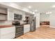 Modern kitchen with white cabinets, wood countertops, and stainless steel appliances at 9792 Wild Oak Dr, Windermere, FL 34786