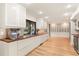 Modern kitchen with white cabinets, wood countertops, and stainless steel appliances at 9792 Wild Oak Dr, Windermere, FL 34786