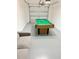 Finished garage converted to a game room with a pool table at 1572 Flange Dr, Davenport, FL 33896