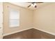 Well-lit bedroom featuring hardwood floors and a window with blinds at 1907 Lazy Oaks Loop, Saint Cloud, FL 34771