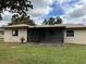 House back view with screened patio and grassy yard at 205 Briar Cliff Dr, Longwood, FL 32779