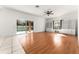 Bright Gathering room with laminate wood floors, built-in shelving, and sliding glass doors leading to the pool at 2657 W Dover Glen Cir, Orlando, FL 32828