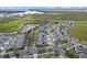 Aerial view of townhouses located near a lake and surrounding landscape at 506 Rainbow Springs Loop, Groveland, FL 34736